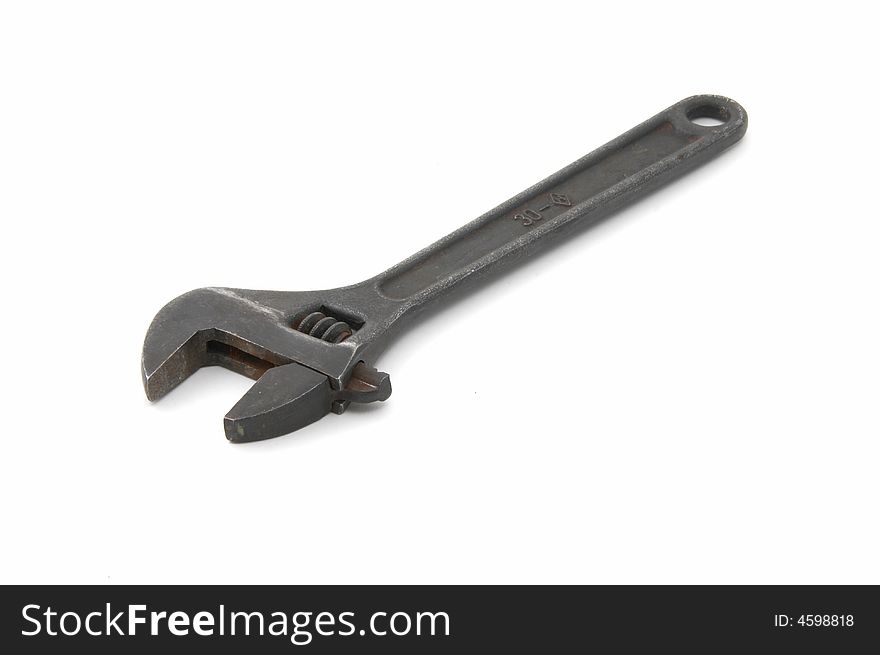 Iron adjustable spanner on a white background