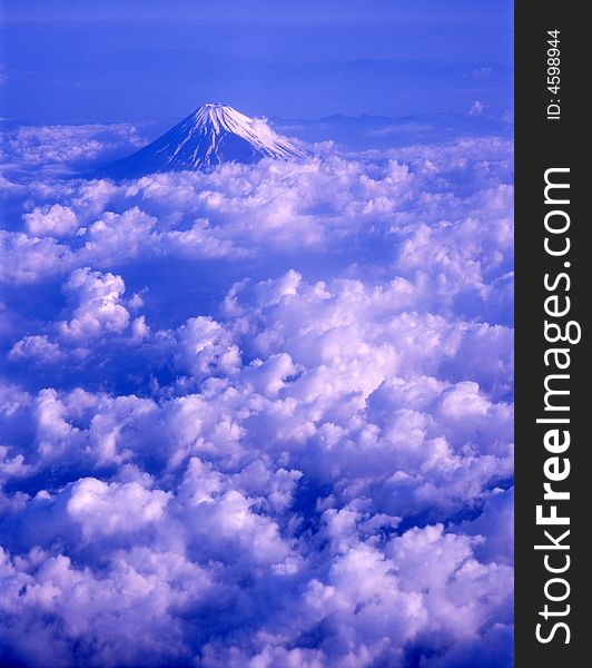 Majestic Mount Fuji rising up through a sea of clouds. Majestic Mount Fuji rising up through a sea of clouds