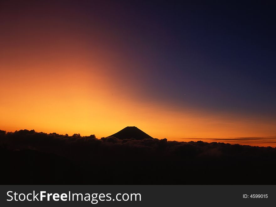 A fiery sunrise over the silhouette of sacred Fuji. A fiery sunrise over the silhouette of sacred Fuji