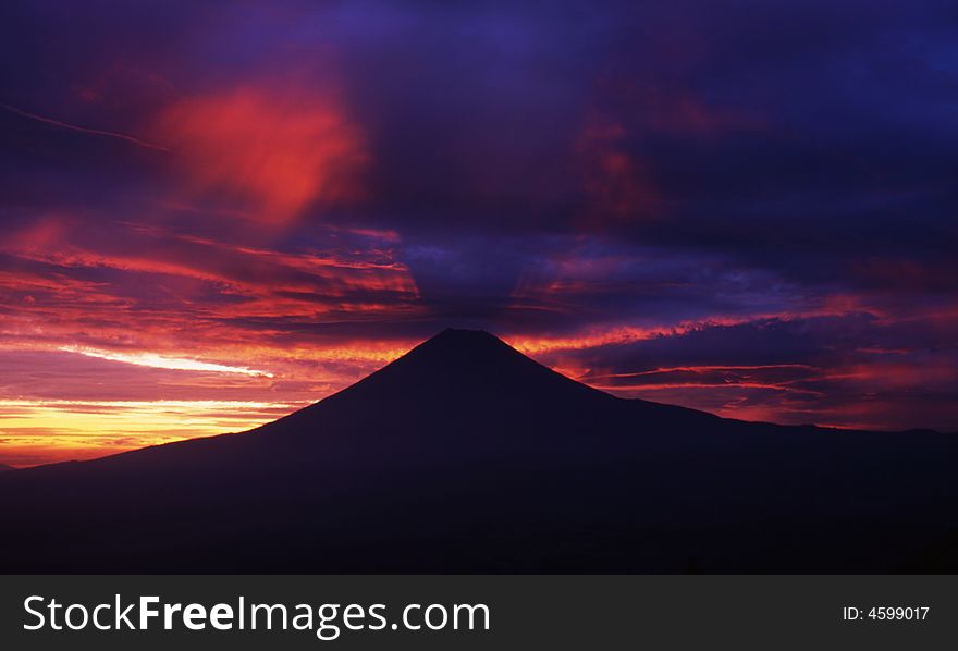 Dramatic and colorful sunrise over the silhouette of Mt. Fuji. Dramatic and colorful sunrise over the silhouette of Mt. Fuji