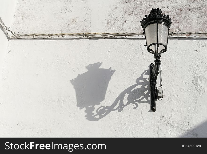 Wall with lamp and shadow, Tarifa