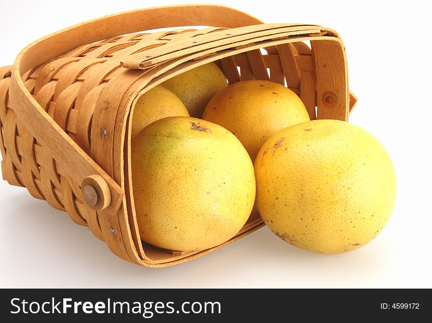 Fresh Oranges rolling out of wicker basket. Fresh Oranges rolling out of wicker basket