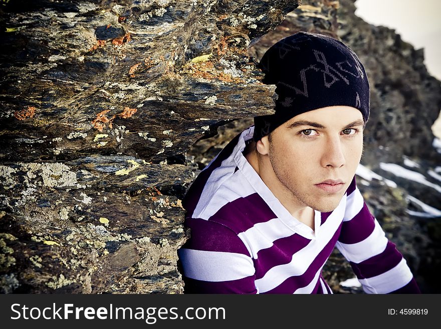 Young man portrait in casual clothing on the rocks. Young man portrait in casual clothing on the rocks