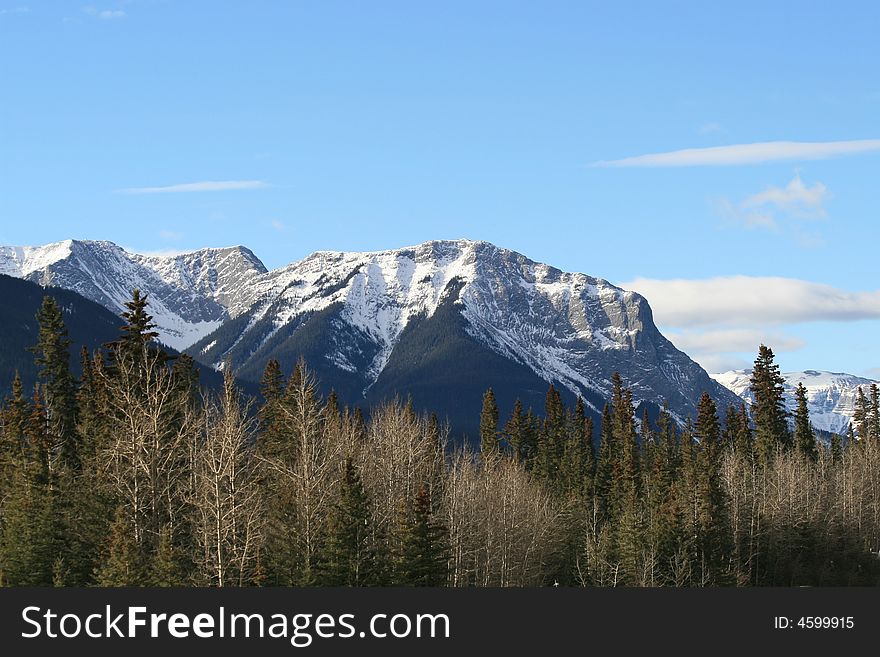 A rugged snow covered mountain in the rocky mountain range, in Jasper, Alberta. A rugged snow covered mountain in the rocky mountain range, in Jasper, Alberta