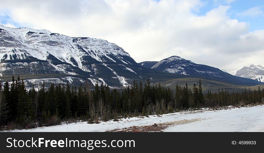 A rugged snow covered mountain in the rocky mountain range, in Jasper, Alberta. A rugged snow covered mountain in the rocky mountain range, in Jasper, Alberta