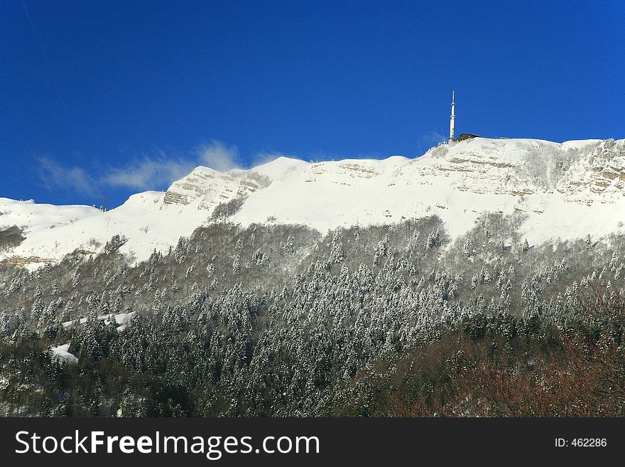 A snowy cliff bare on the top of the mountain. A snowy cliff bare on the top of the mountain