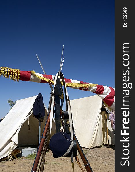 Tents and flag and armament on display at a civil war encampment. Tents and flag and armament on display at a civil war encampment.