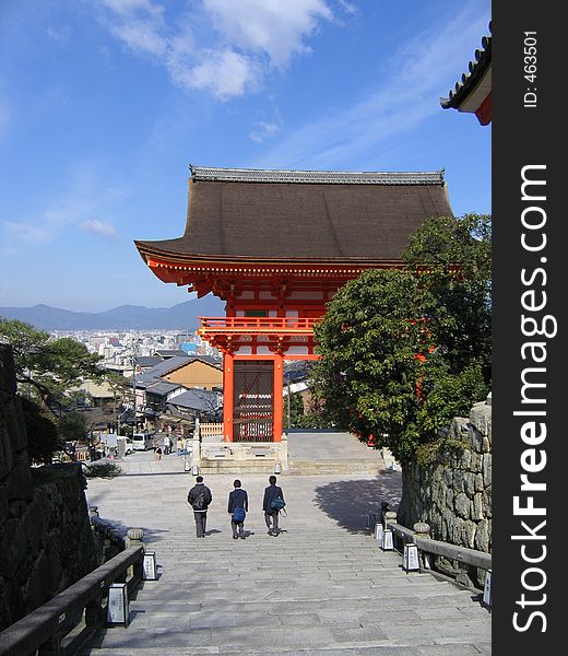 Three school boys walking down a flight of stairs out of a temple. Three school boys walking down a flight of stairs out of a temple