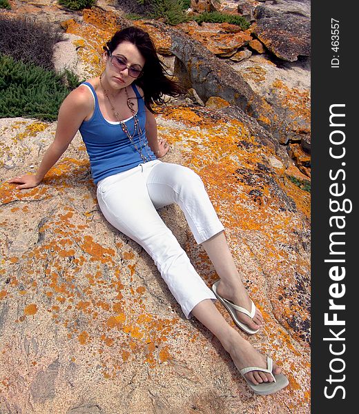 Girl sitting on Rock thinking. Girl sitting on Rock thinking