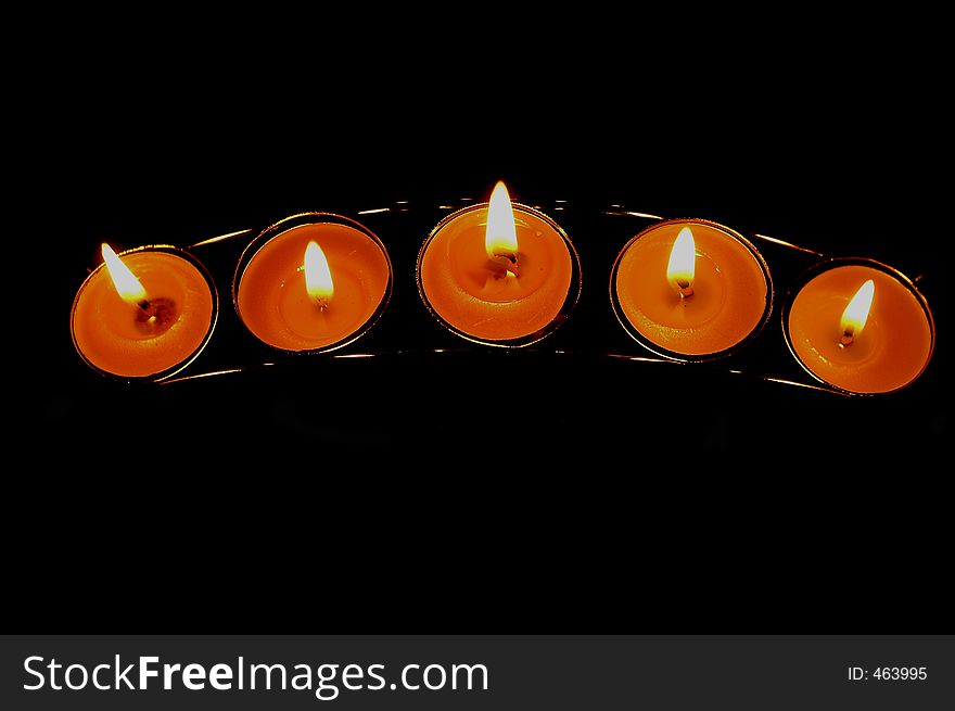 Shot of five candles on black background