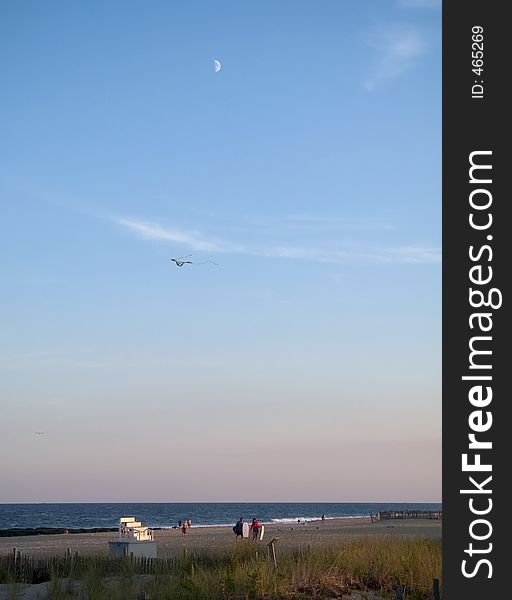 This is a shot of a daytime moon and kite along the Jersey shore. This is a shot of a daytime moon and kite along the Jersey shore.