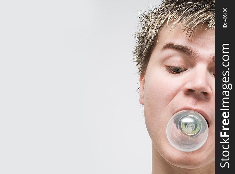 High Key - Portrait of a young man with a lightbulb in his mouth. High Key - Portrait of a young man with a lightbulb in his mouth