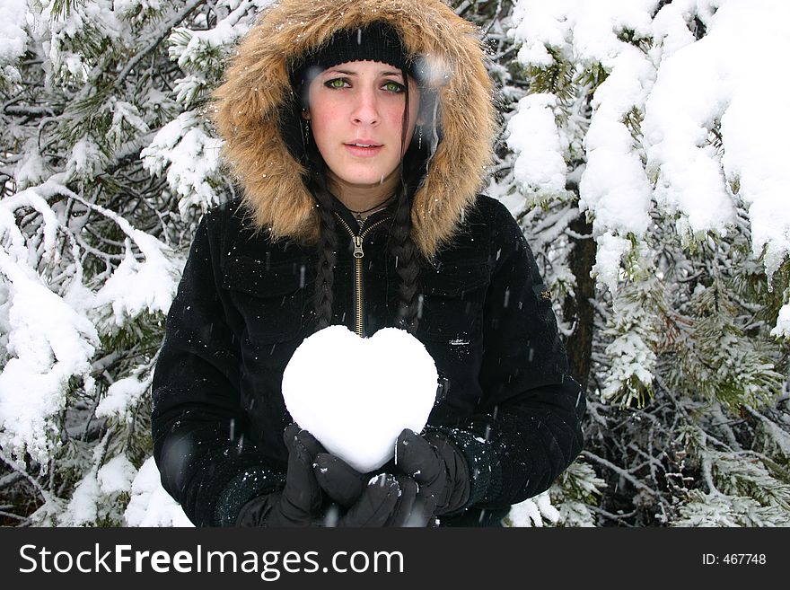 Sad Girl hold a heart while standing in the snow. Room for copy. Sad Girl hold a heart while standing in the snow. Room for copy