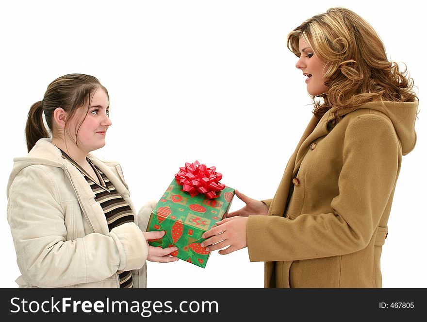 Two young girls in winter coats with a Christmas gift. Shot with a Canon 20D. Two young girls in winter coats with a Christmas gift. Shot with a Canon 20D.