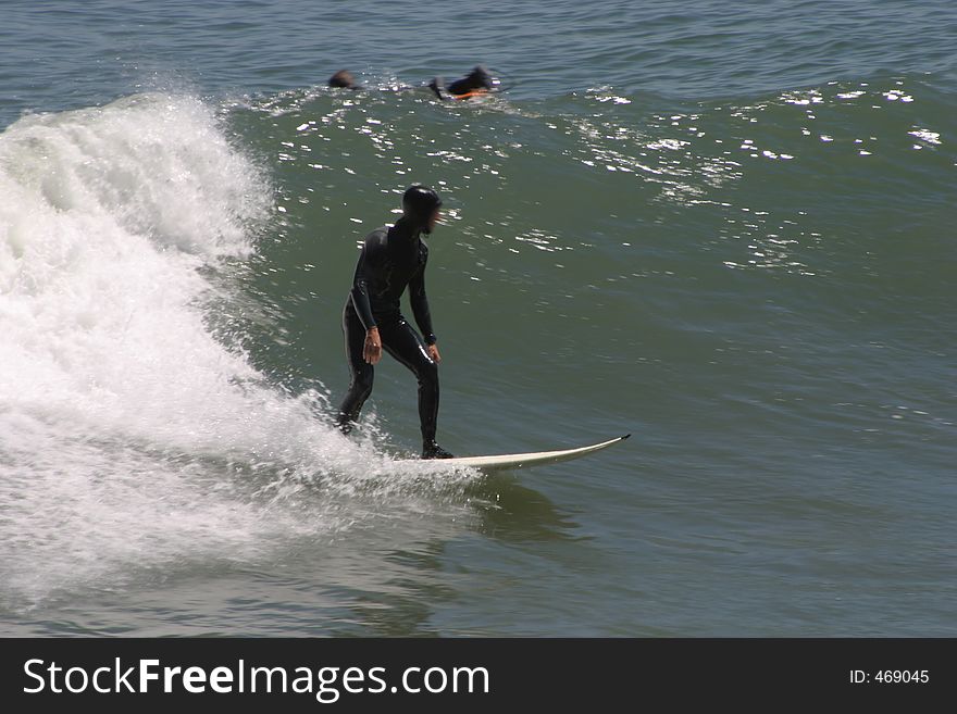 A surfer in the cold water of northern california. A surfer in the cold water of northern california.