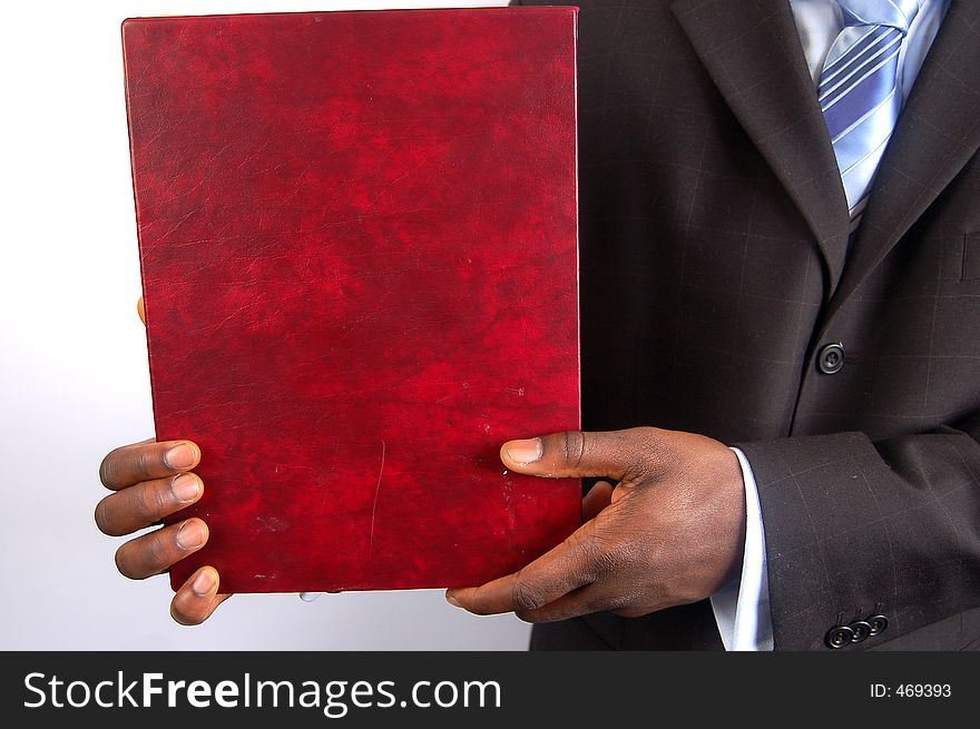 This is an image of black business man presenting a portfolio. This is an image of black business man presenting a portfolio.