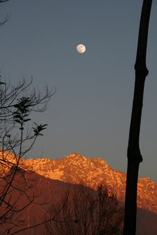 Fullmoon Rise And Vivid Sunset On Snowpeaked In Royalty Free Stock Photography Fullmoon Rise And Vivid Sunset On Snowpeaked In Royalty Free Stock Photography
