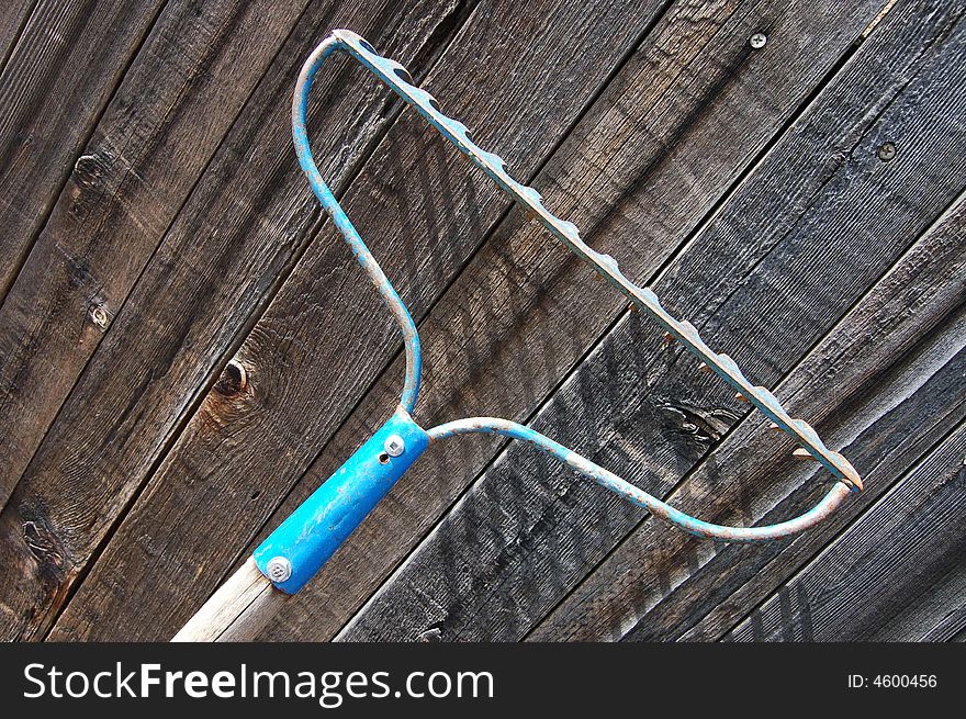 Garden Rake against fence background