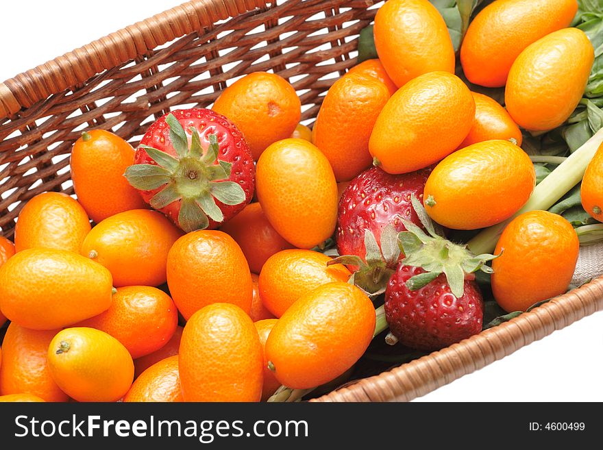 A lot of kumquats and strawberry in a basket