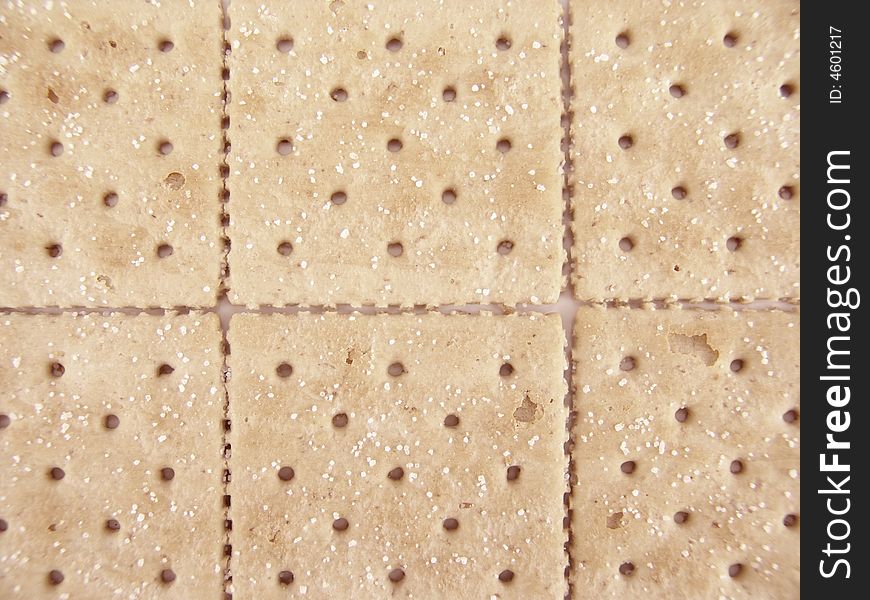 Whole wheat crackers aligned side-by-side to create background