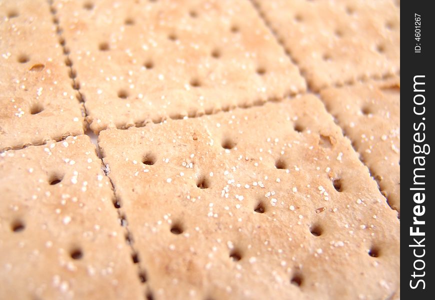 Whole wheat crackers aligned side-by-side to create background