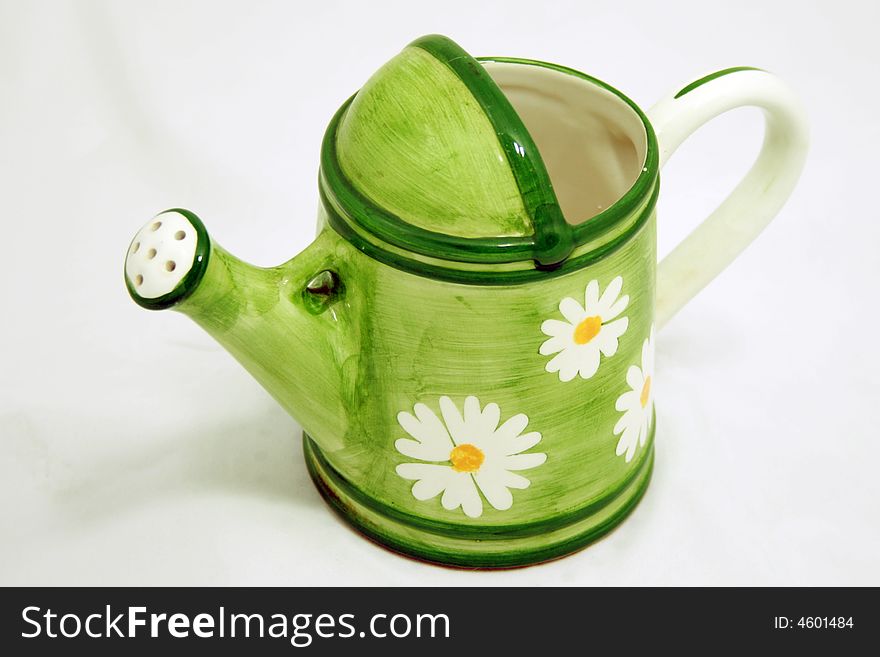 A photo of light green watering can. A photo of light green watering can.