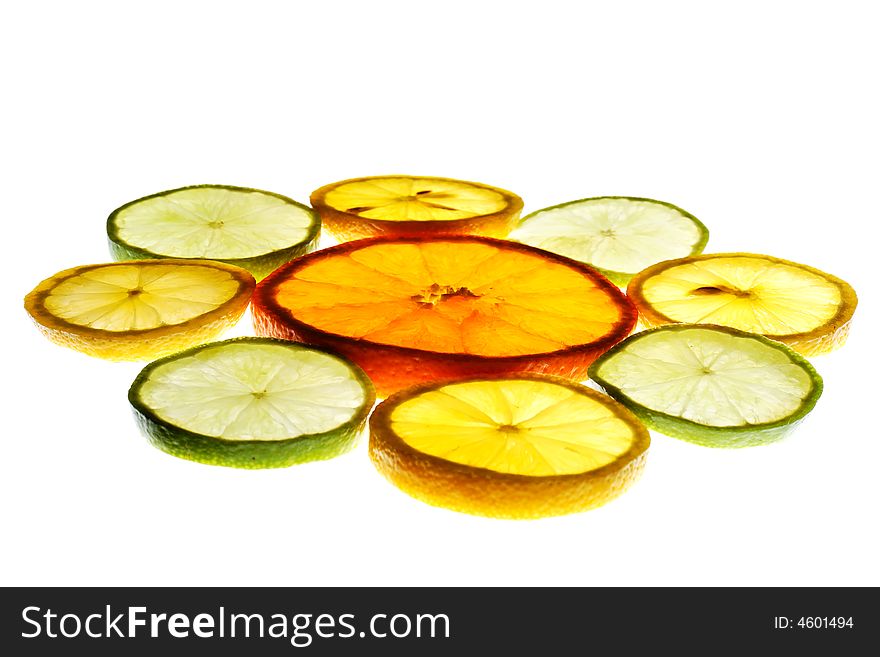 Orange slice surrounded with lemon and lime slices isolated on white background