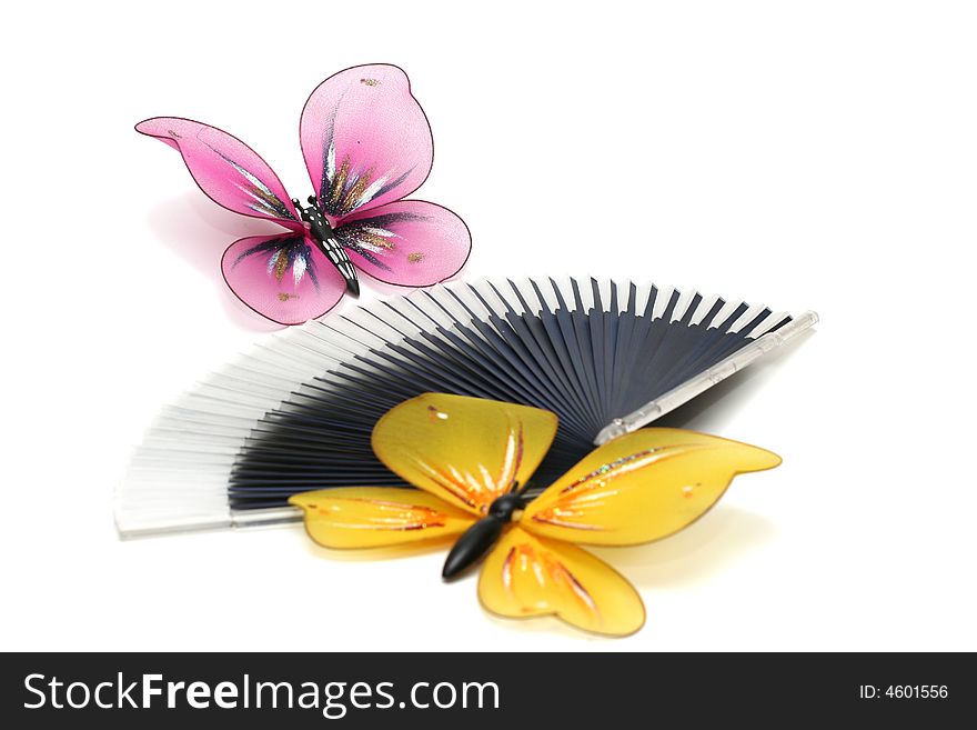 The artificial, plastic butterfly on a fan, focus on distant butterfly