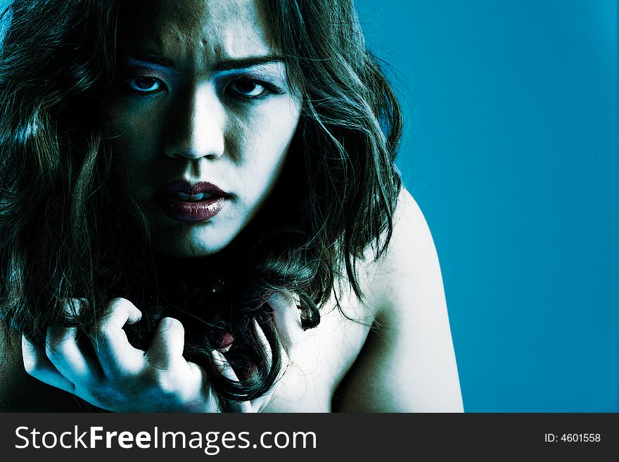 Young chinese girl on a blue background. Young chinese girl on a blue background