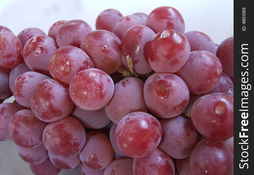 Red grapes on a white background