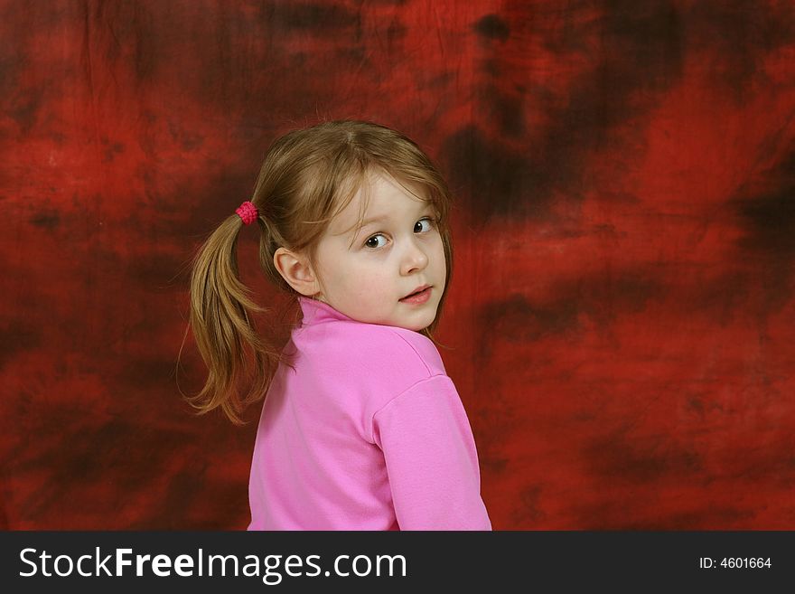 The lonely child on a red background, a sad sight. The lonely child on a red background, a sad sight