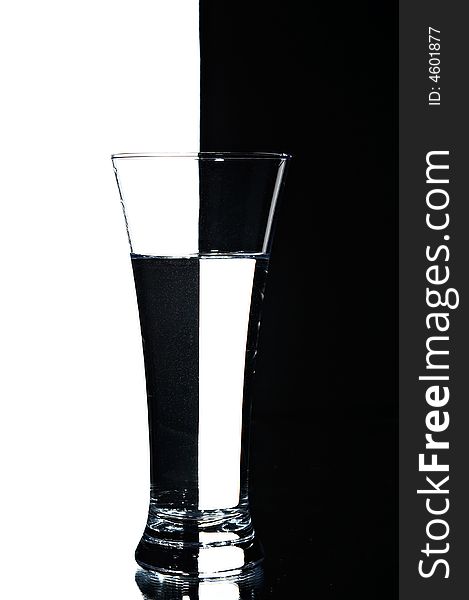 Glass with water on the white and black background