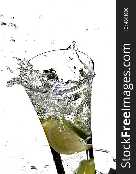 Glass with water and lemon on the white background