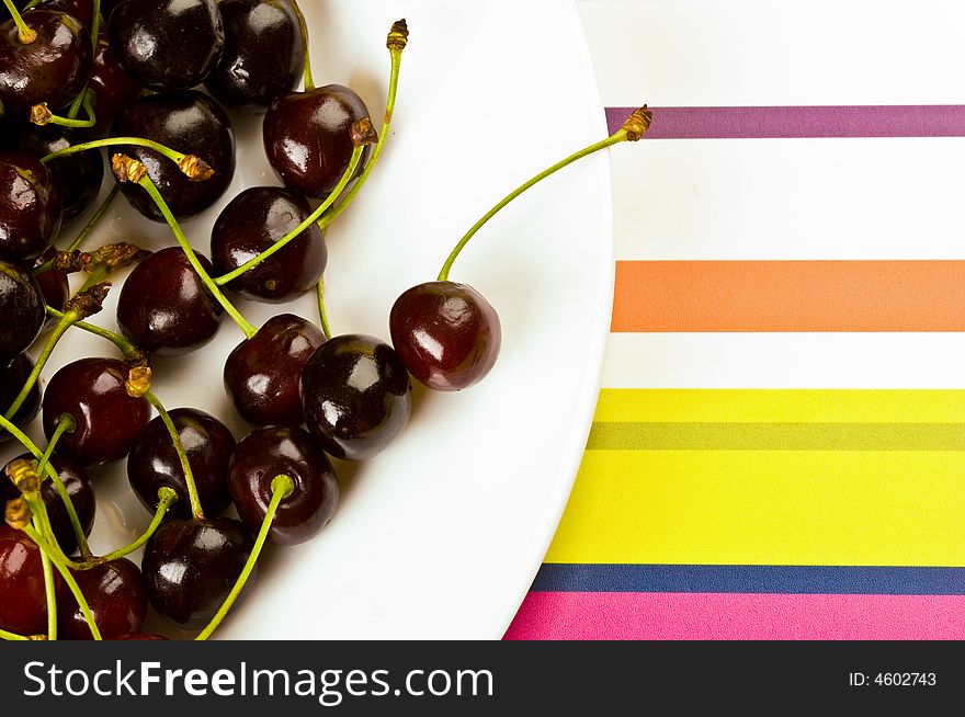 Some ripe cherries on the colored background