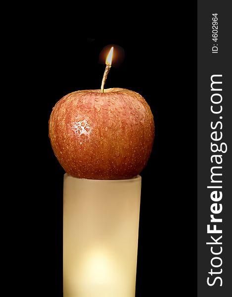 Wet apple burning ling a candle