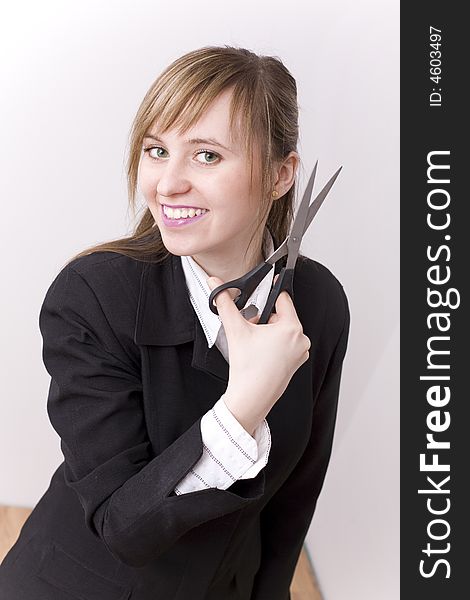 An attractive woman with scissors on the hand.