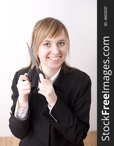 Smilling woman with scissors on the hands.