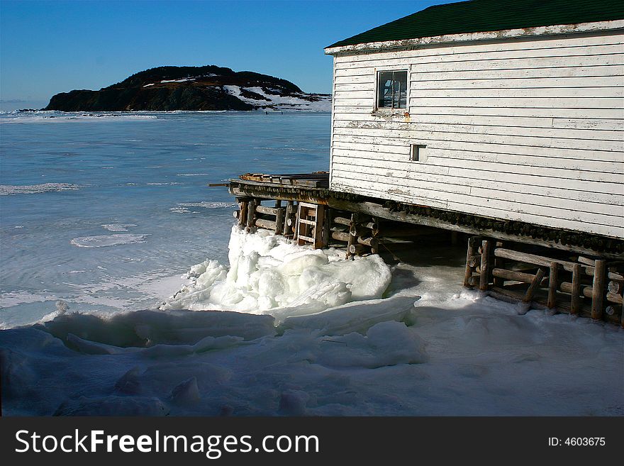 A wharf and stage on the icy winter ocean. A wharf and stage on the icy winter ocean
