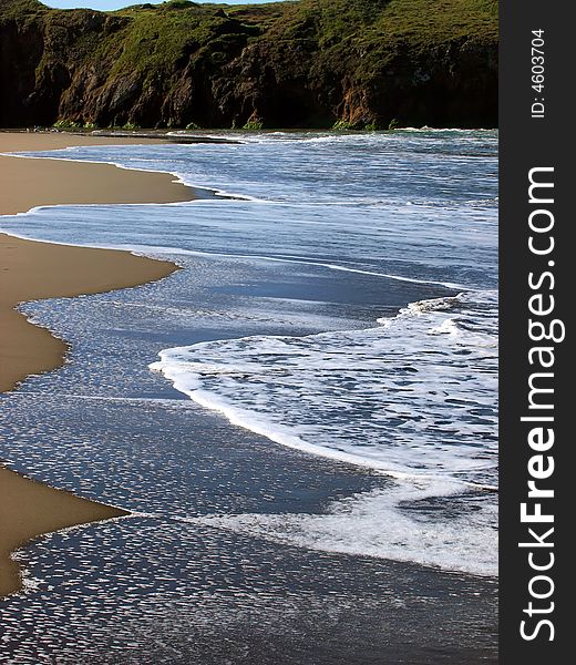 Northern California beach and cliffs with  receding wave. Northern California beach and cliffs with  receding wave