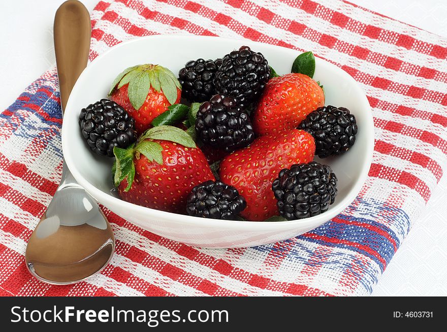Bowl filled with fresh picked strawberries and blackberries. Bowl filled with fresh picked strawberries and blackberries.