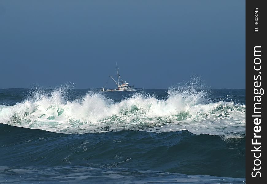 Fishing trawler heading out with ocean waves in forground. Fishing trawler heading out with ocean waves in forground
