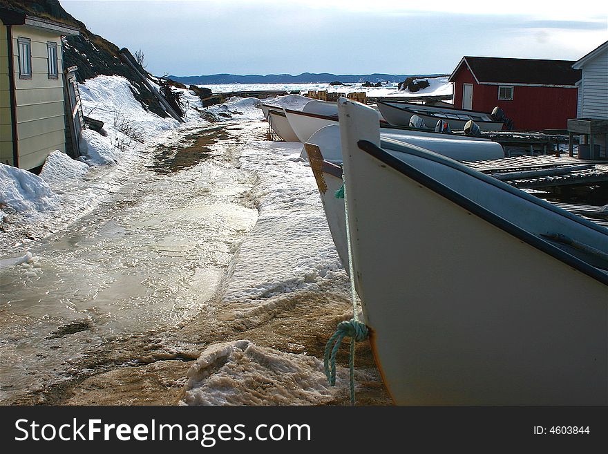 Icy winter wharf where the fishing boats are stored in Twillingate, Newfoundland. Icy winter wharf where the fishing boats are stored in Twillingate, Newfoundland