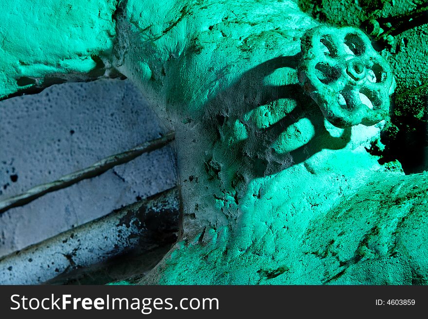 Old sewer pipe with valve and electric wire on whitewashing wall. Old sewer pipe with valve and electric wire on whitewashing wall