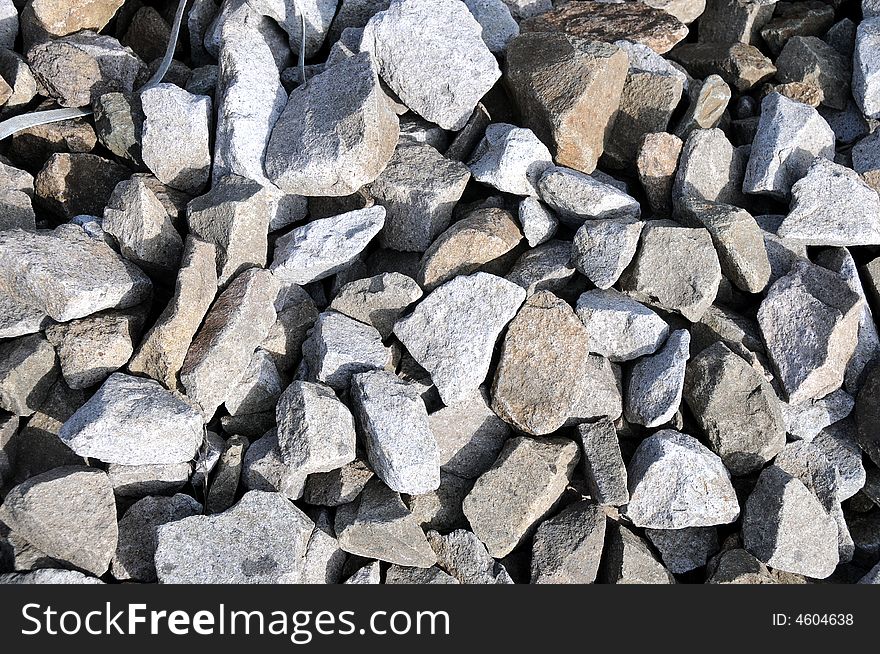 Different stones between tracks on a railway station as background. Different stones between tracks on a railway station as background