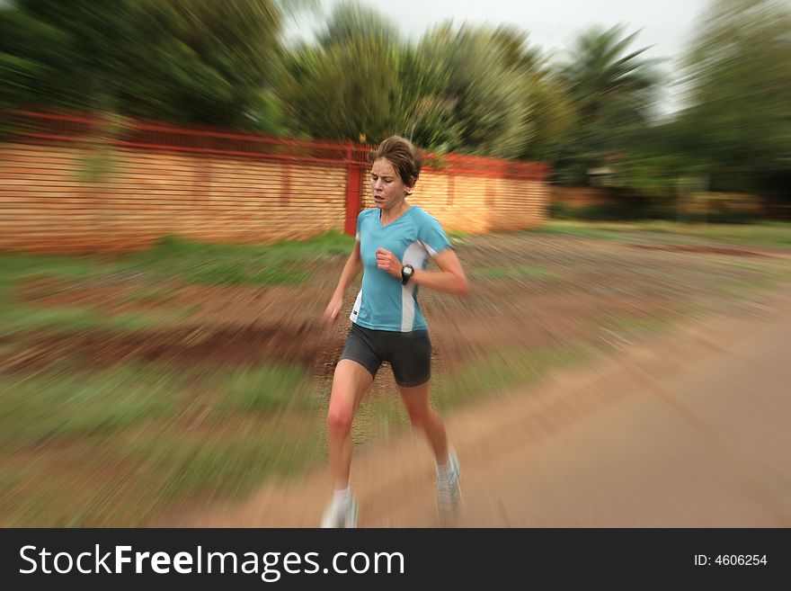 Female athlete in white training fast. Female athlete in white training fast.