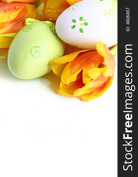 Green easter eggs with orange tulips