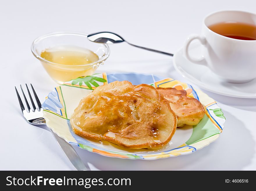 Two pancakes with honey on plate, lunch