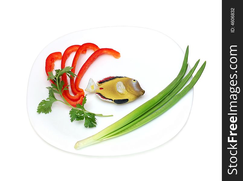 Concept toy fish on a plate isolated over a white background