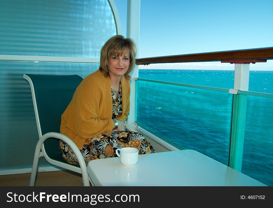 Lady sitting outside her stateroom early in the morning. Lady sitting outside her stateroom early in the morning.