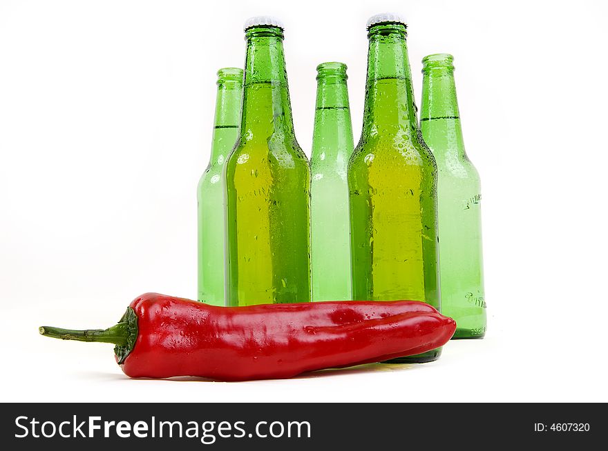 Cold beer botle over spicy hot chili. Cold beer botle over spicy hot chili